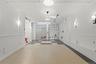 Corridor with track lighting and inlaid floor details