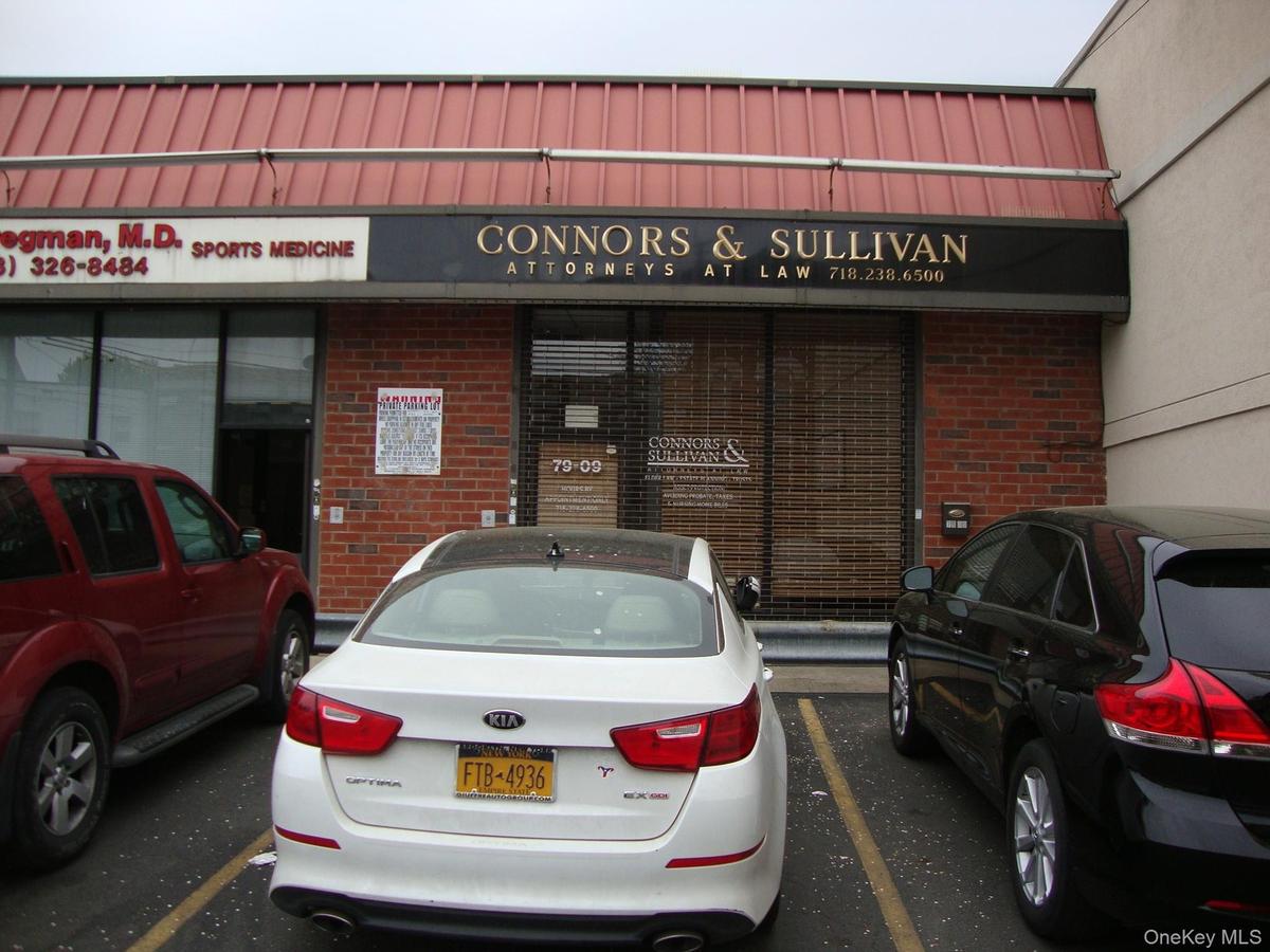 View of building exterior with uncovered parking