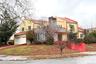Mediterranean / spanish home with a tiled roof, a chimney, driveway, and an attached garage
