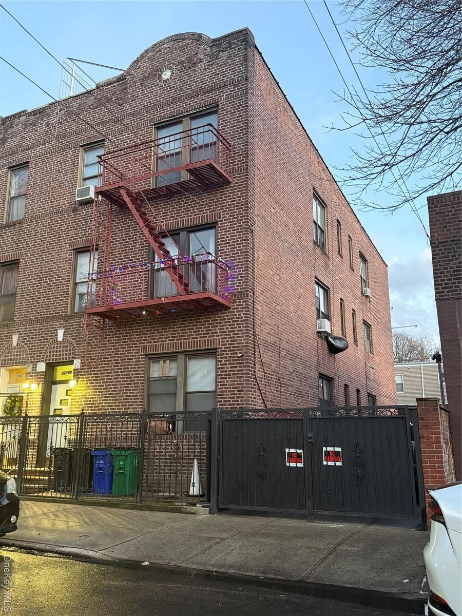 View of apartment building / complex featuring a fenced front yard
