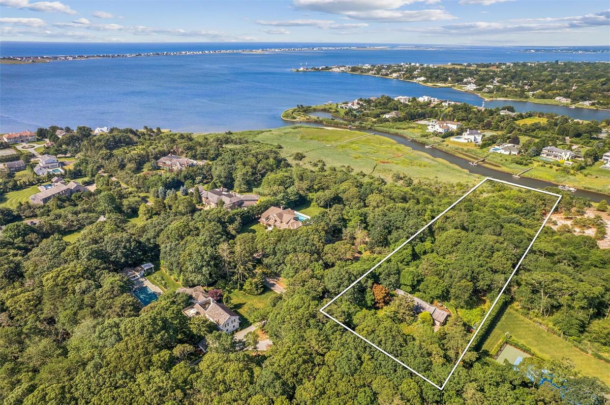 Aerial overview of property's location with a nearby body of water and property boundaries highlighted