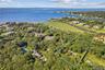 Aerial overview of property's location with a nearby body of water and property boundaries highlighted