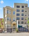 View of apartment building / complex featuring a fenced front yard