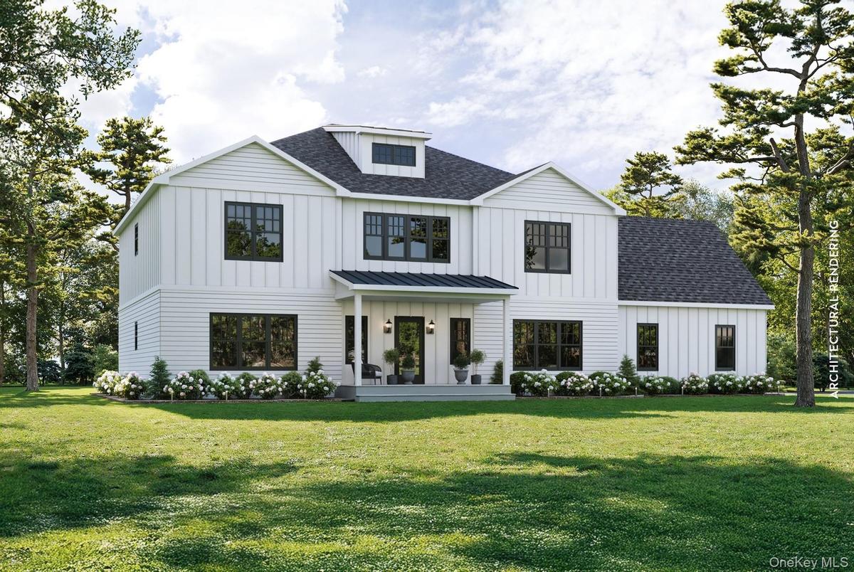 View of front of home with board and batten siding, a shingled roof, covered porch, and a front yard