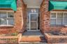 Entrance to property featuring brick siding