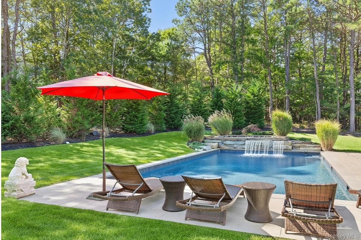 Outdoor pool with a lawn and a patio