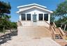 View of front of home featuring stairway and a wooden deck