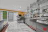 Indoor wet bar featuring open shelves, ornamental molding, dishwasher, light stone counters, and recessed lighting