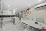 Kitchen with crown molding, recessed lighting, wainscoting, a peninsula, and white cabinetry