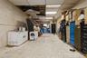Below grade area with a paneled ceiling and fridge