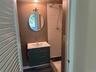 Full bathroom with vanity and a shower stall