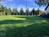 View of grassy yard facing County Rd. 48