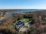 Aerial view of property and surrounding area featuring a large body of water