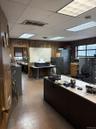 Office area with wooden walls and a drop ceiling