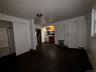 Unfurnished basement with arched walkways and radiator heating unit