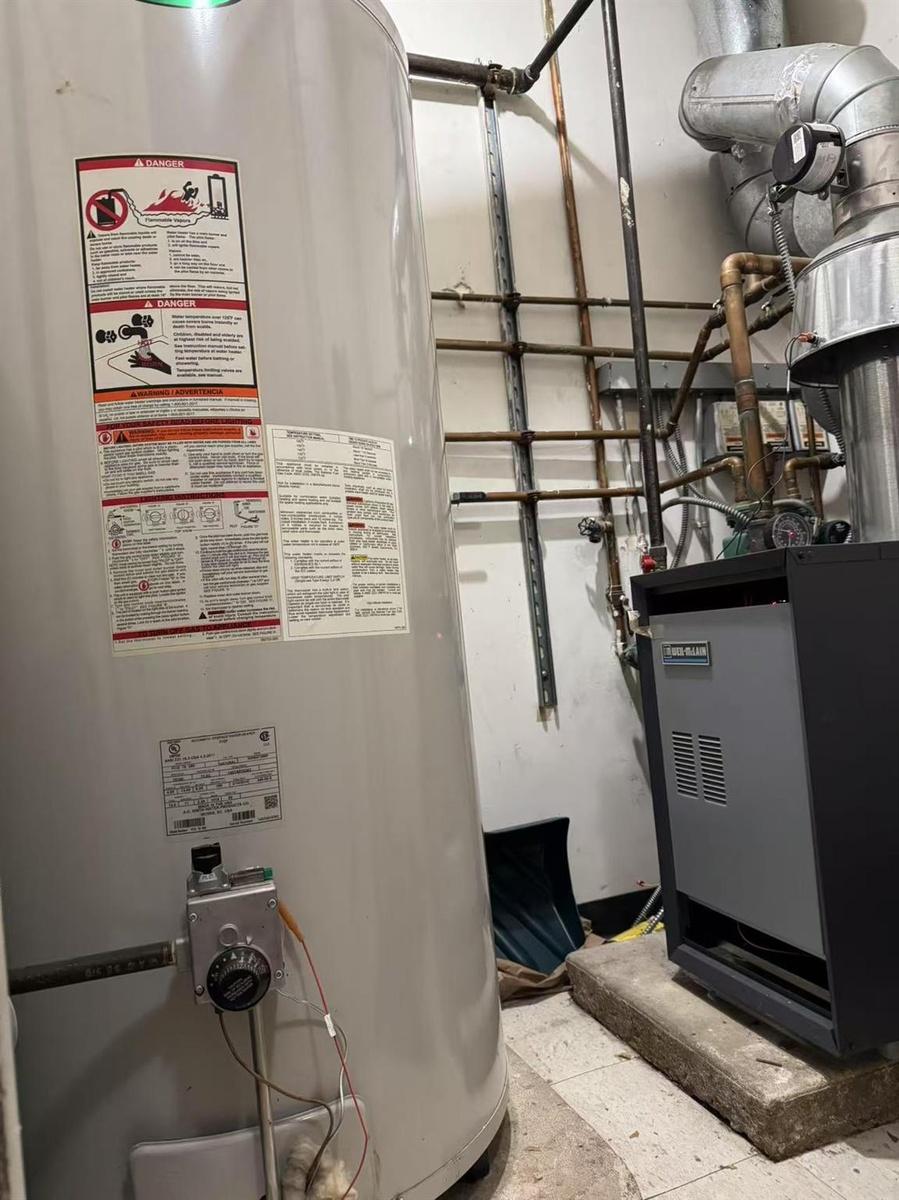 Utility room featuring gas water heater