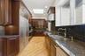 Kitchen with  skylight, hardwood  floors,  stone counters,  and hi end stainless steel appliances