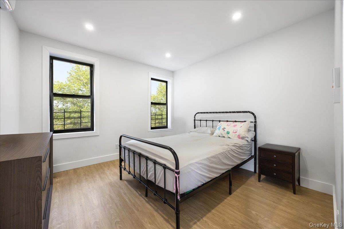 Bedroom with light wood-type flooring and recessed lighting