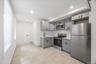 Kitchen featuring gray cabinetry, stainless steel appliances, light countertops, recessed lighting, and light tile patterned floors