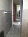 Bathroom with tile walls, tile patterned flooring, and wainscoting