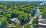 Aerial view of property and surrounding area featuring a nearby body of water
