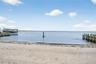 View of water and beach from living area