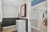 Bathroom with vanity, ornamental molding, and light wood-style flooring