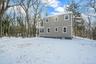 View of snow covered back of property