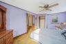 Bedroom featuring light colored carpet, a closet, ceiling fan, and ornamental molding
