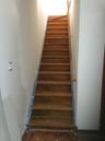 Staircase with baseboards and wood finished floors