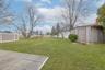 Fenced backyard featuring a storage shed