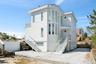 Back of property with stucco siding and stairs