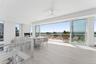 Wooden deck featuring a water view and outdoor dining area