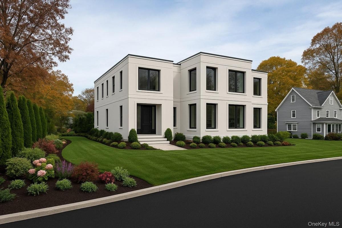 Contemporary house featuring stucco siding and a front lawn