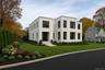 Contemporary house featuring stucco siding and a front lawn