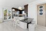 Kitchen with dark stone countertops, a kitchen bar, and light wood finished floors