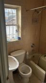 Full bath with bathtub / shower combination, tile patterned floors, and tile walls