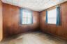 Empty room featuring wood walls