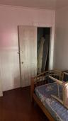 Bedroom with dark wood-type flooring and baseboards