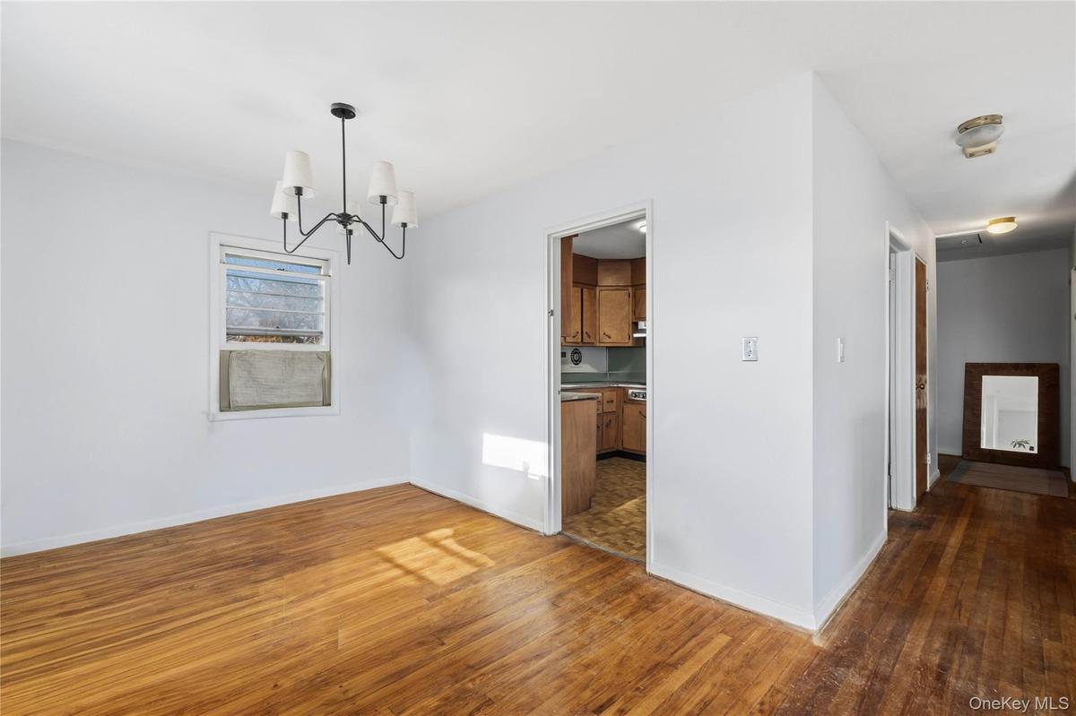 Unfurnished dining area featuring a chandelier and hardwood / wood-style flooring