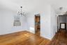 Unfurnished dining area featuring a chandelier and hardwood / wood-style flooring
