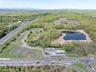 Birds eye view of property with a water view and a view of trees