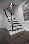 Staircase featuring wood finished floors and baseboards