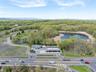 Drone / aerial view featuring a water and mountain view and a wooded view