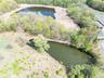 Drone / aerial view featuring a water view and a forest view