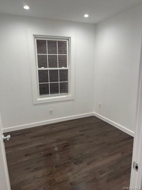 Unfurnished room featuring dark wood-type flooring and recessed lighting
