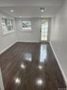 Bedroom featuring plenty of natural light, dark wood-type flooring, and recessed lighting. Access to the patio