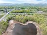 Birds eye view of property with a water and mountain view and a wooded view