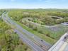Birds eye view of property featuring a water view and a forest view