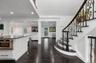 Entrance foyer featuring a decorative wall, dark wood-type flooring, wainscoting, crown molding, and recessed lighting